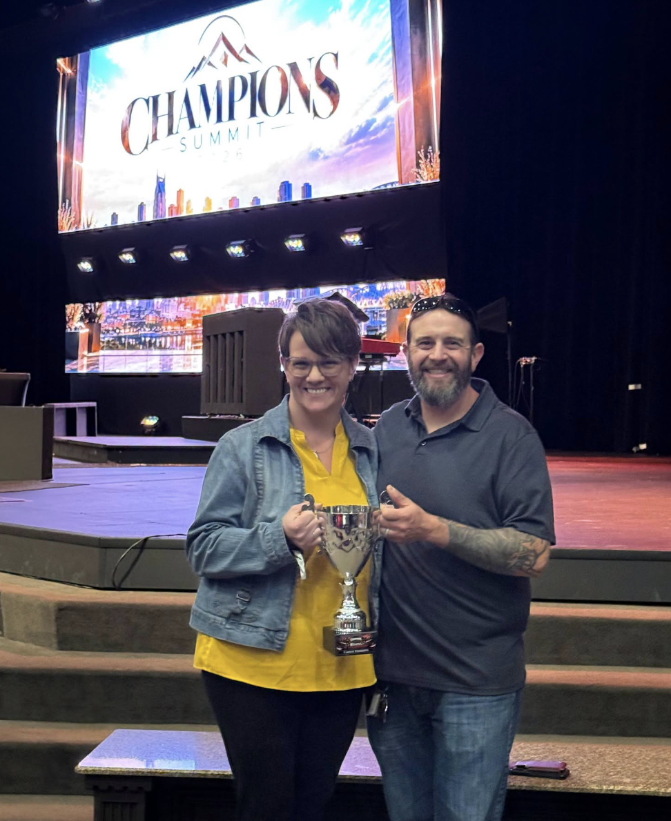 Candy holding Rising Champion and leadership awards